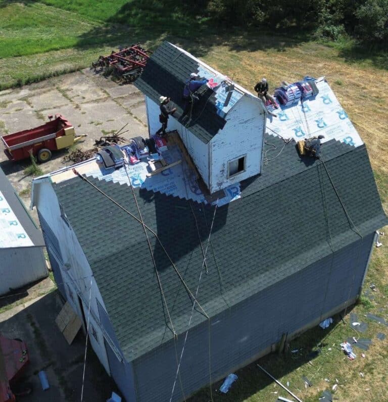 Miguel Rivera 14 Rainforcing Roofing & Exteriors expert performing a detailed roof inspection to identify storm damage.